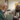 Catholic Charities employee holding a yogurt container with a spoon helping and older man