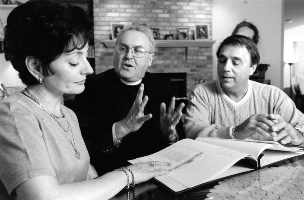 Old photo of Father Rubey talking with two people