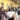 Group of people around a restaurant round table and smiling at the camera.