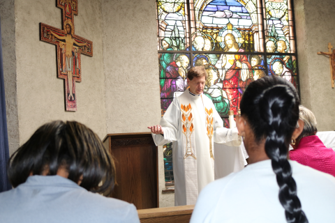 Priest leading a prayer at the Madonna House