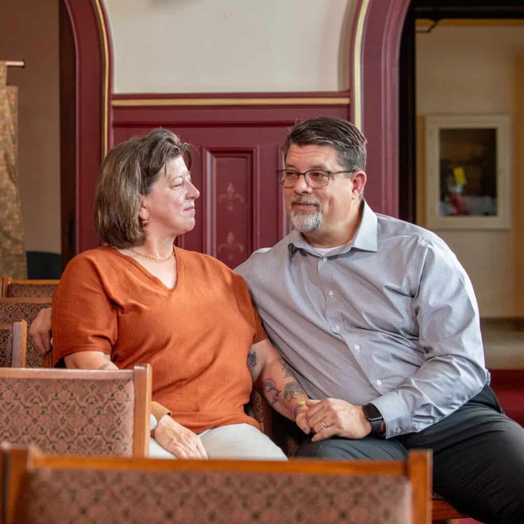 Two parents holding hands at LOSS program