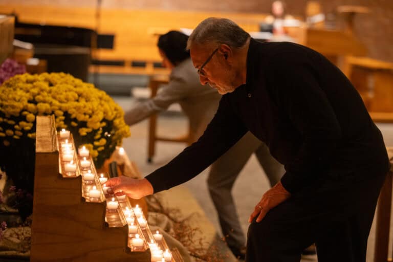 People lighting candles at LOSS evening of remembrance