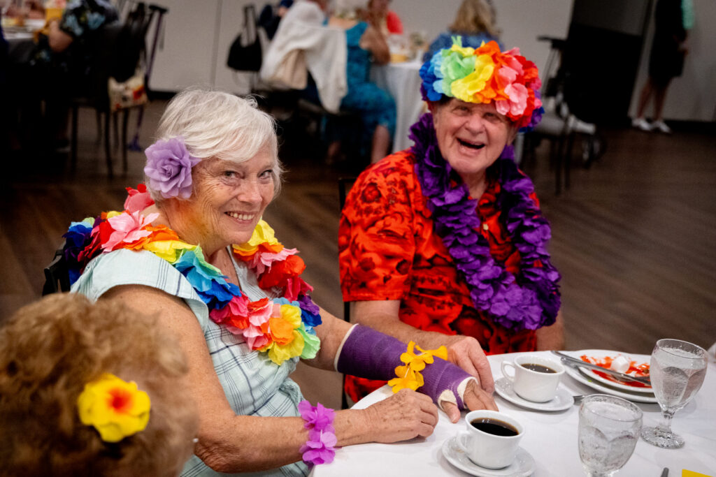 97-year-old Lillian Gomonka, 83-year-old Gerry Cushing and 86-year-old John Schintgen at a senior luau in Ingleside, Illinois.