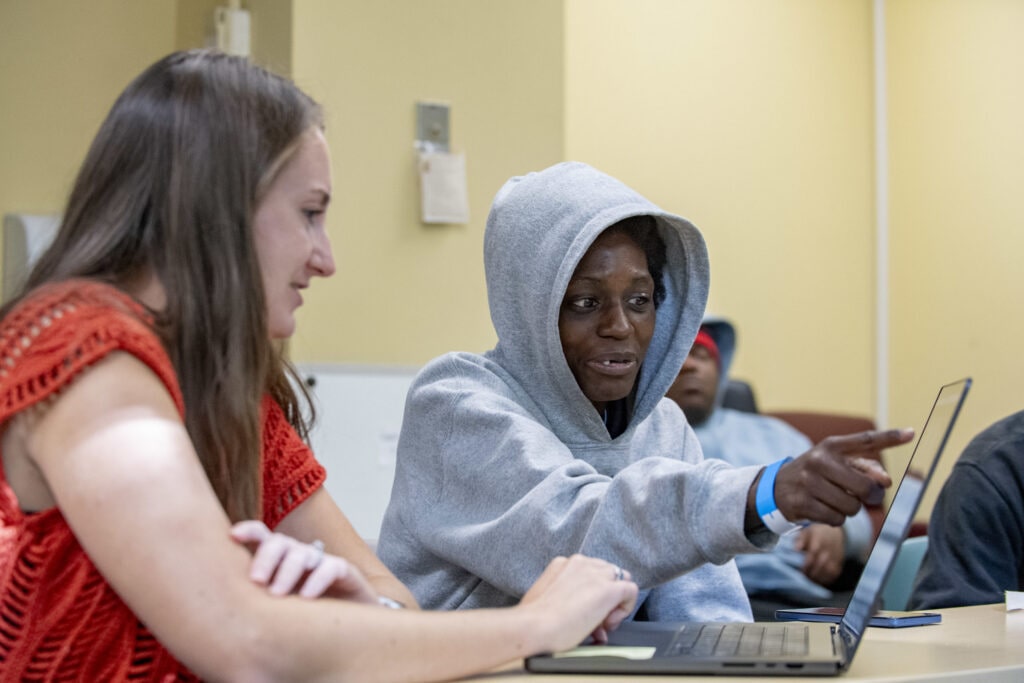 Two women during an editing session for the After Supper Visions program hosted by the Catholic Charities of the Archdiocese of Chicago