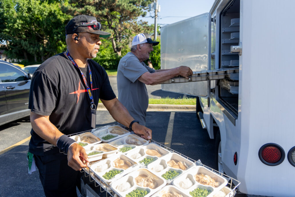 Shariff Banks loads trucks to be delivered for meals on wheels in Waukegan, Illinois.