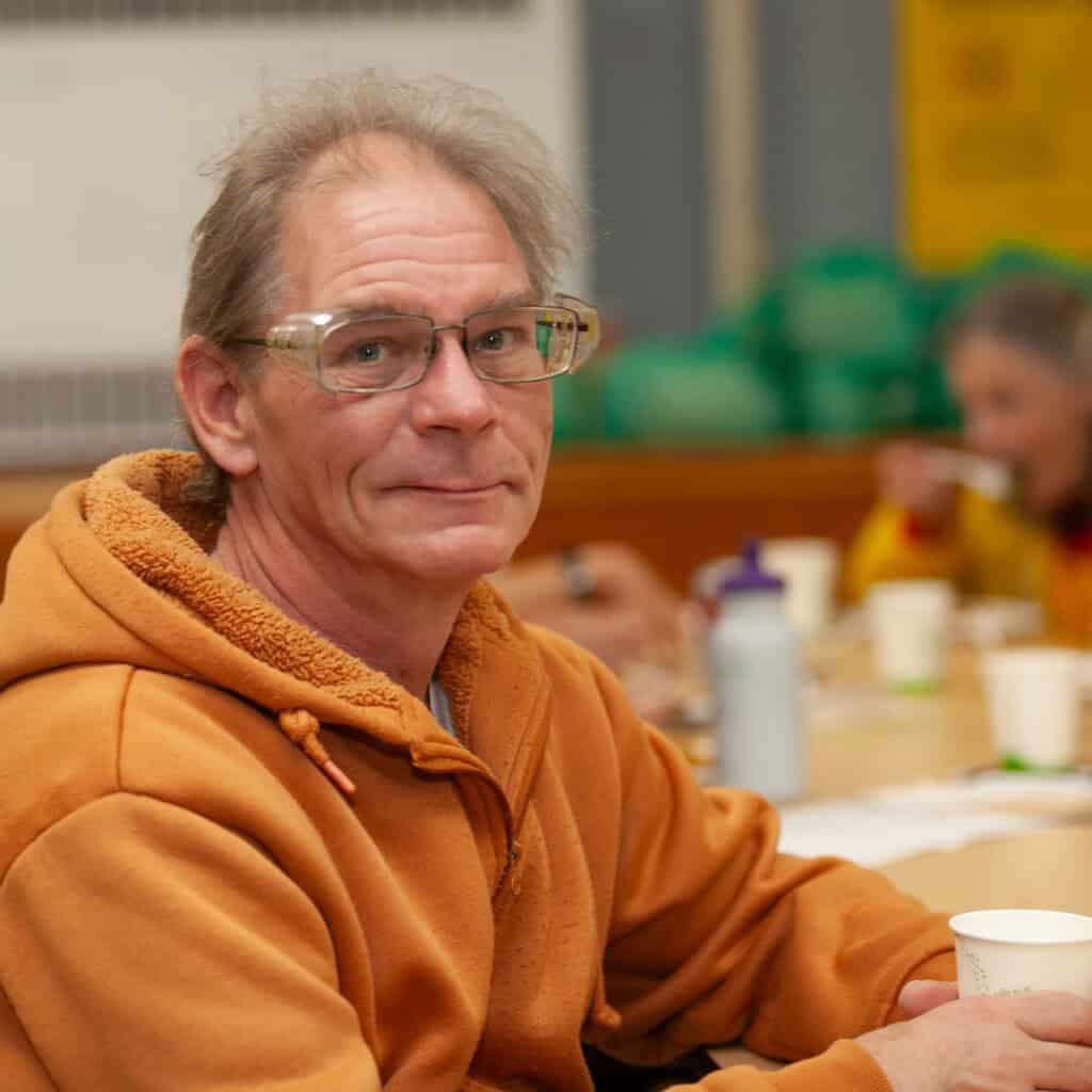 Senior drinking warm beverage