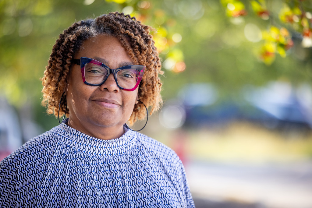 Woman smiling outside affordable housing for seniors headshot