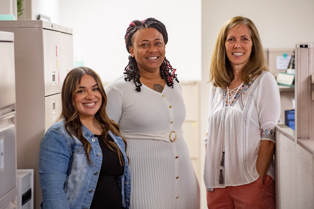 3 women standing in office