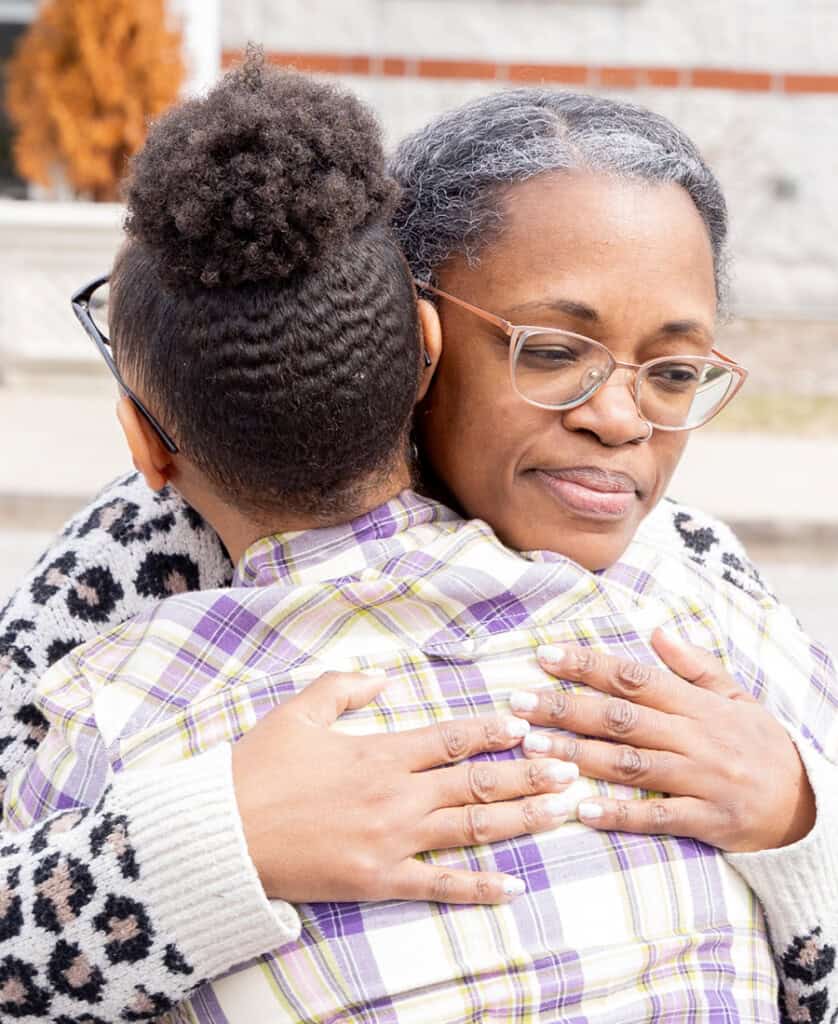 Woman hugging her daughter
