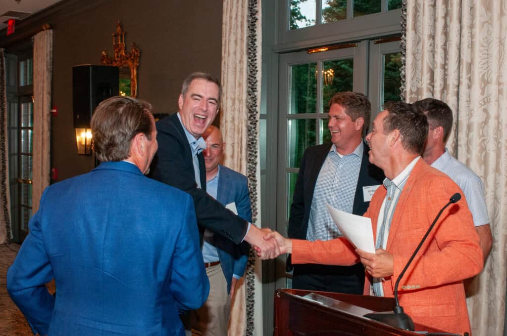 Catholic Charities Golf Classic attendees shaking hands