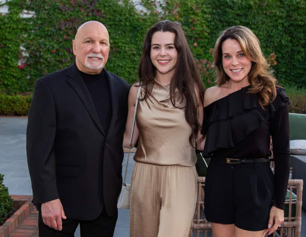 3 people smiling for photo at Art of Caring fundraiser