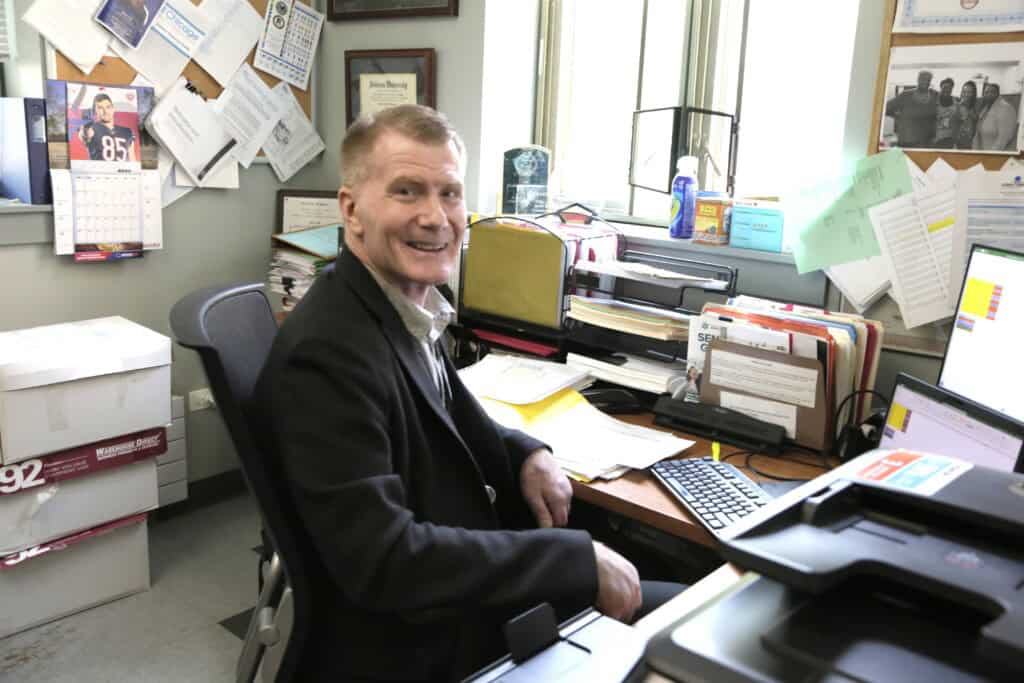 David Dempsey sitting at his desk at the St. Leo Residence for veterans.