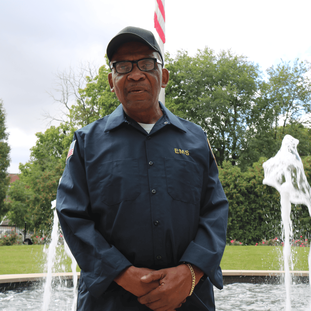 EMS employee in front of fountain