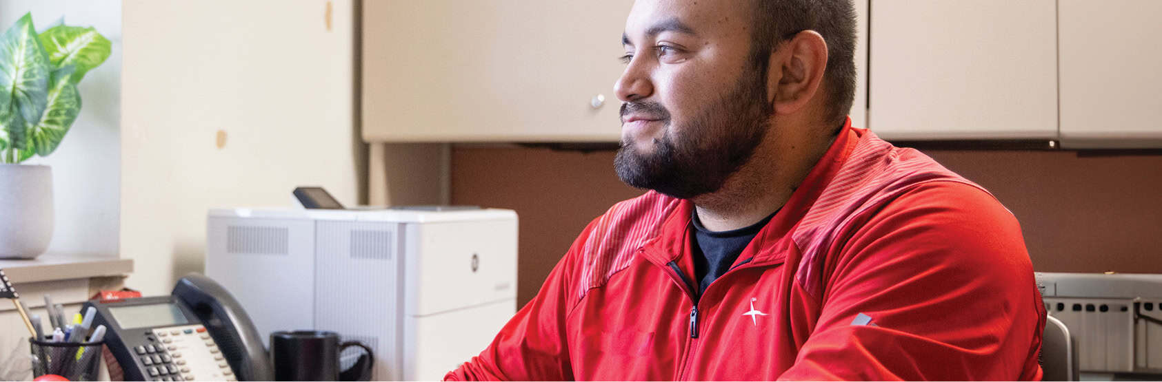 Catholic Charities employee sitting at a desk