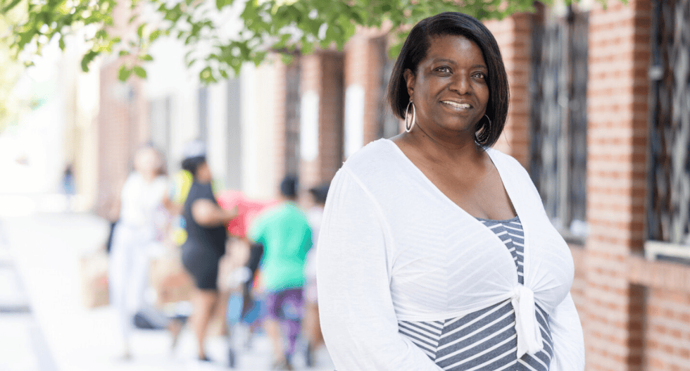 Sharon Holmes smiling outside of food pantry