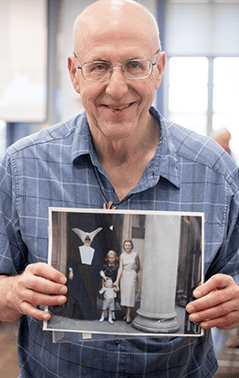 Man holding up a photograph